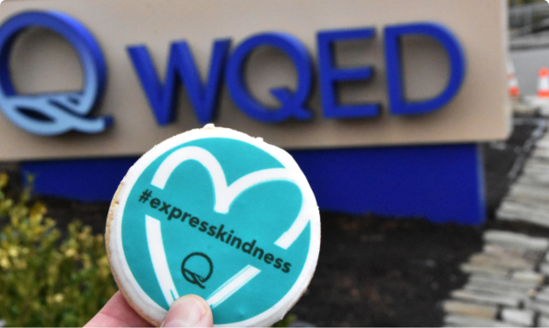 Express Kindness cookie with WQED sign in the background