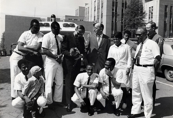Group of Freedom House men along with founder Phil Hallen outside Pittsburgh's Presbyterian Hospital.