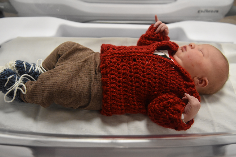 Newborn baby in cardigan