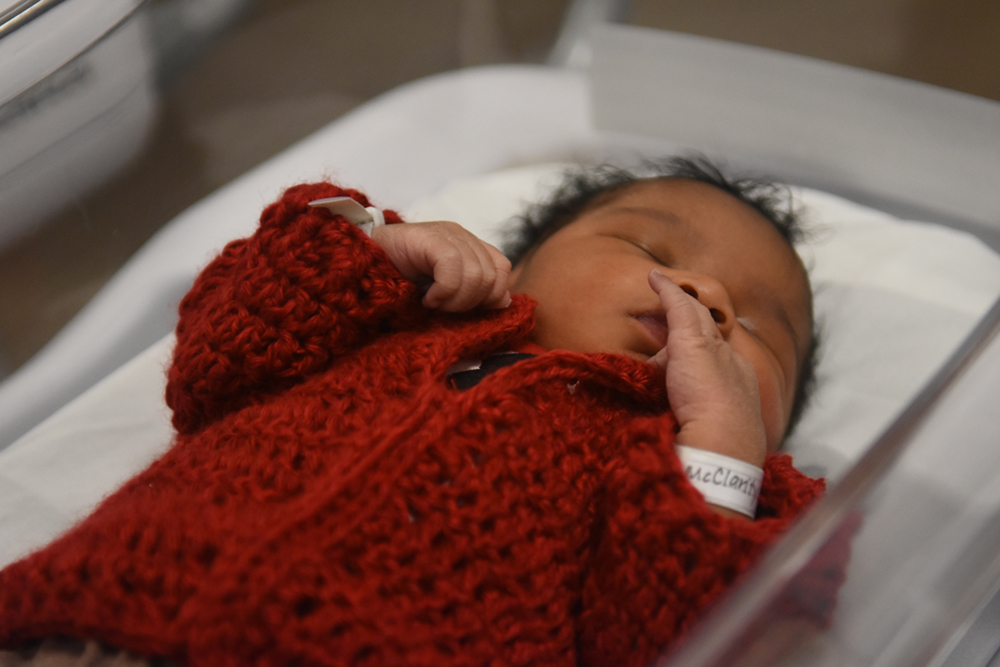Newborn baby in cardigan