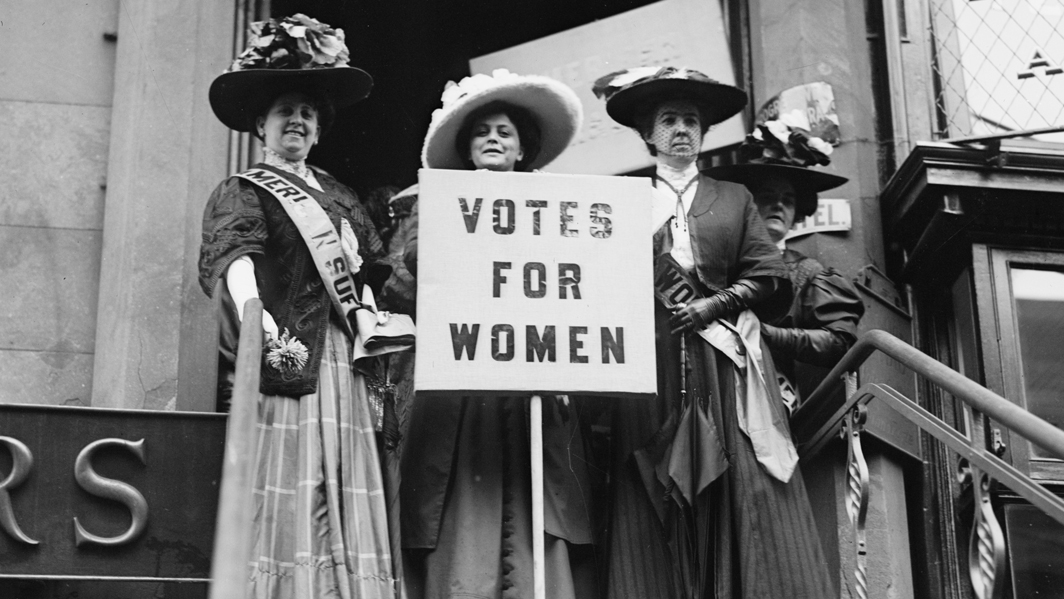 Photo of suffragette women holding Votes for Women placard