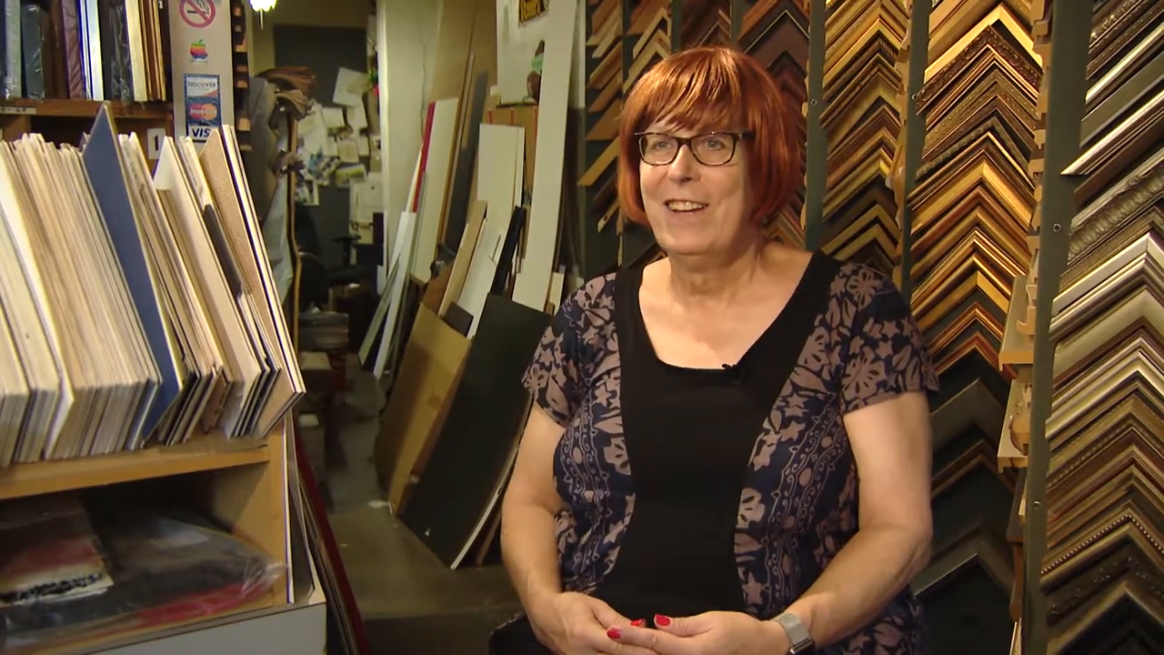 Wendi Miller seated in a picture frame shop