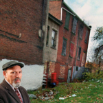 August Wilson stands in front of his childhood home.