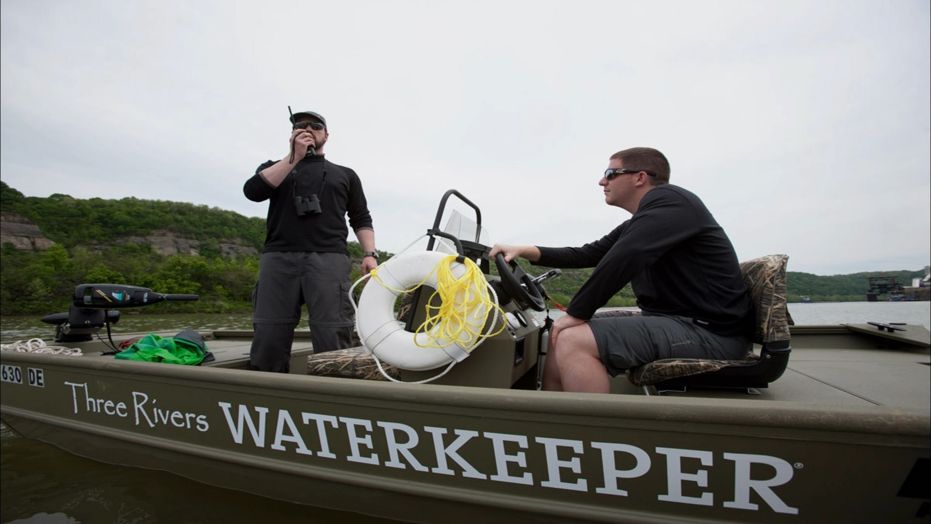 Two members of Three Rivers Waterkeeper on their boat